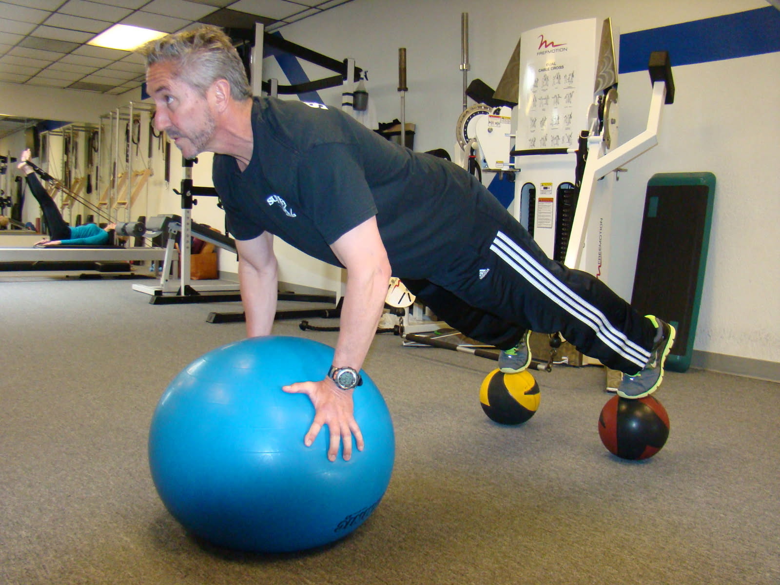 Norman McCallson, founder of Supreme Fitness, doing a stability ball plank in the Irvine studio